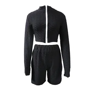 Close-up details of the textured athletic zip top and shorts set, showing stretchy honeycomb fabric.