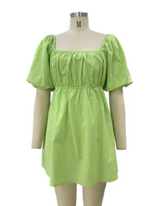 Light green square neck puff sleeve dress detail view, showing elegant pleats and fabric texture.