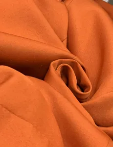 Orange suit fabric texture detail, premium material close up for women fashion wear.