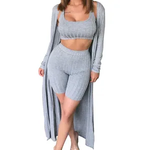 Close-up detail of the grey ribbed three-piece lounge set showing texture, crop top and shorts.