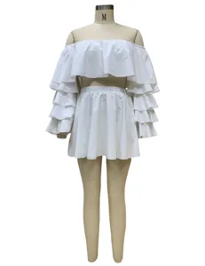 White off-shoulder ruffle crop top and mini skirt two-piece set clothing detail display.