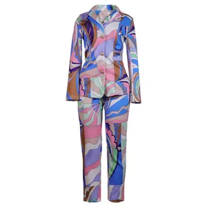 Colorful abstract geometric print two-piece suit, elegant blazer and matching trousers.