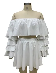 White two-piece set detail showing off-shoulder layered ruffle sleeves and mini skirt.