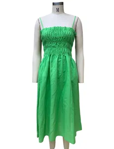 Green spaghetti strap dress detail, high waist gathered bust design, casual summer apparel.