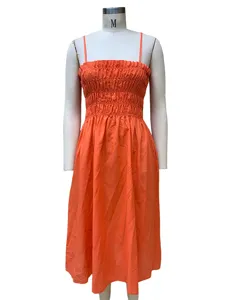 Orange smocked strappy midi dress for women, stylish high waist summer dress outfit.