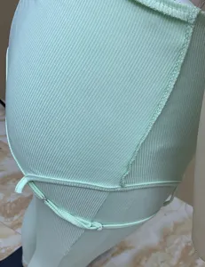Ribbed camisole jumpsuit detail in light green, slim fit stretch knit fabric for summer.