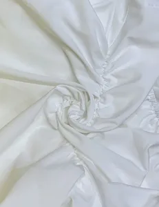 White ruched ruffle fabric detail shot, perfect for fashionable women clothing design.
