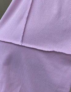 Pink ribbed knit fabric detail of women's slim fitted casual bodysuit, soft and stretchy.