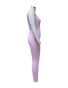 Side view of a pink ribbed cami jumpsuit, showing slim fit and stretchy knit texture detail.