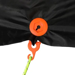 Detail van kampeertent luifelclip met oranje kunststof bevestigingsgesp en reflecterend touw.