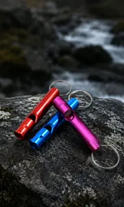 Portable aluminum alloy survival whistles with keyrings in vibrant colors for camping gear.