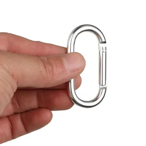 Close-up detail shot of silver oval aluminum alloy carabiner spring snap hook for outdoor use.