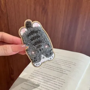 Detailed macro view of a soft grey and white fuzzy cartoon cat hair patch sticker accessory