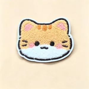Detailed view of a cute plush cat hair patch featuring soft and fluffy embroidered texture