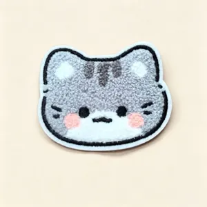 Close-up of cute plush cat-head shaped fringe hair sticker with soft texture
