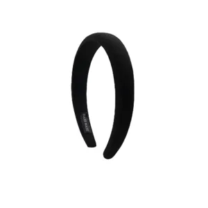 Minimalist black padded headband for high-volume hair styling.