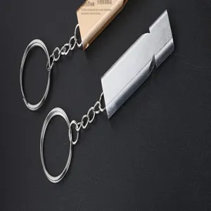 Detail shot of portable metal survival whistles with key rings, durable outdoor gear.