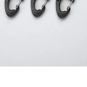 Mini plastic figure-8 carabiner wire spring buckle backpack connecting ring detail view.