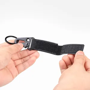 Tactical webbing keychain with black metal snap hook and secure hook-and-loop strap.