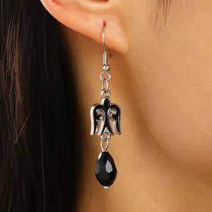 Close-up detail of Kazakh style ethnic drop earring with black faceted teardrop bead