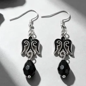 Close-up of Kazakh style silver earrings with black faceted teardrop beads