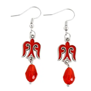 Detailed view of ethnic Kazakh style earrings featuring red enamel and crystal teardrops.