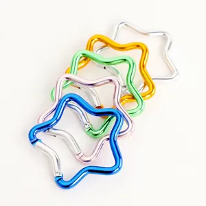Close-up of colorful star-shaped aluminum carabiners, lightweight key chain hooks.