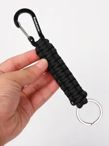Close-up view of the black paracord keychain featuring durable woven nylon and metal carabiner.