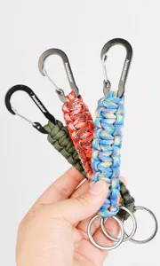 Outdoor DIY paracord woven keychain with metal carabiner and key ring, detail view.
