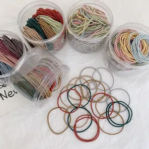 Detail of multi-colored seamless thin hair ties in transparent storage jars
