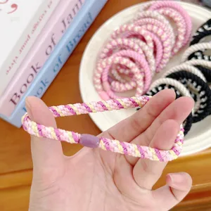 Close-up view of a pink and purple woven high-elastic hair tie showing the texture