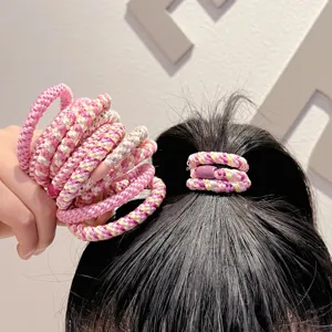 Detailed shot of pink woven high-elasticity hair ties styling a sleek high ponytail