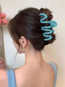 Elegant blue wavy hair claw clip styled in a classic bun hairstyle for a chic look.