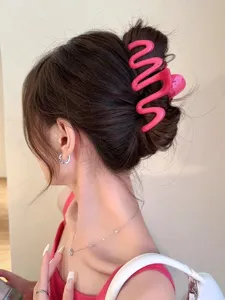 Hot pink wave-shaped hair claw clip for elegant bun styling and thick hair