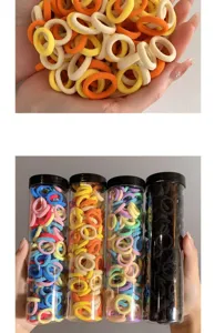 Detail showing multi-colored children's elastic hair bands in clear storage tubes