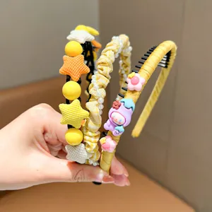 Close-up of yellow children's headbands with star and pearl decorations