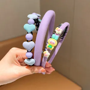Detailed view of children's purple hair hoops with cute heart and rabbit charms