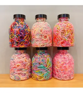 Detailed view of six clear jars filled with colorful high-elasticity hair rubber bands