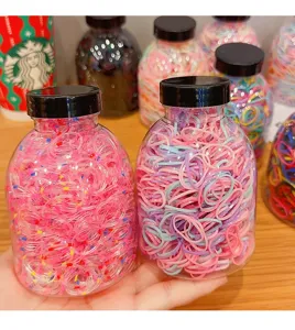 Close-up of colorful elastic hair ties for kids packaged in clear plastic bottles