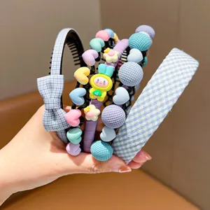 Close-up of set of pastel-colored children's headbands with checkered bow and charms