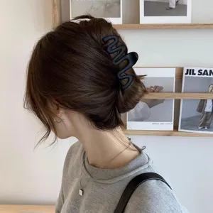 Premium matte black wave-shaped hair claw clip for elegant bun styling and thick hair