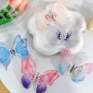 Vibrant collection of 5 pearl butterfly hair clips displayed on white decorative plate