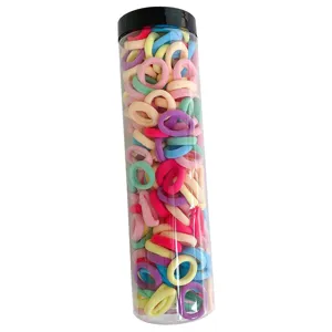 Large transparent jar of multi-colored small elastic hair ties for kids hair styling