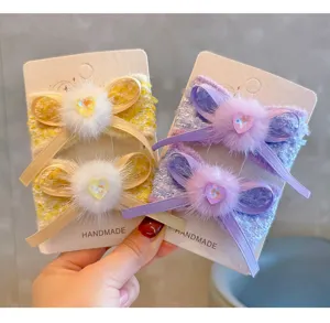 Close-up of French style tweed fur bow hair clips for girls featuring sparkling heart crystals