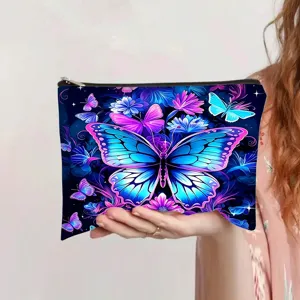 Close-up of a vibrant dreamlike butterfly print canvas cosmetic bag held in hand
