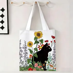 Vista detallada del estampado de gato negro y girasoles en la bolsa de lona blanca.