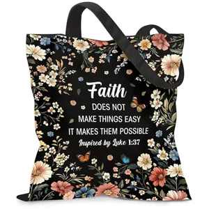 Vista detallada del bolso de lona negro con flores y una gran cita de fe inspiradora