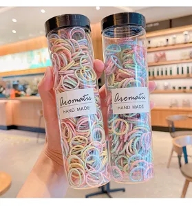 Detailed view of colorful elastic hair bands in transparent storage tubes