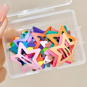 Close-up of colorful star-shaped metal BB hair clips in a clear plastic storage box