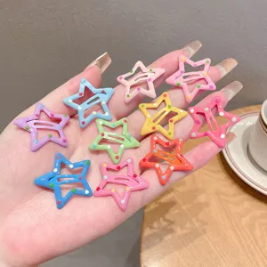 Close-up of colorful star-shaped hair clips with playful polka dots for young girls.